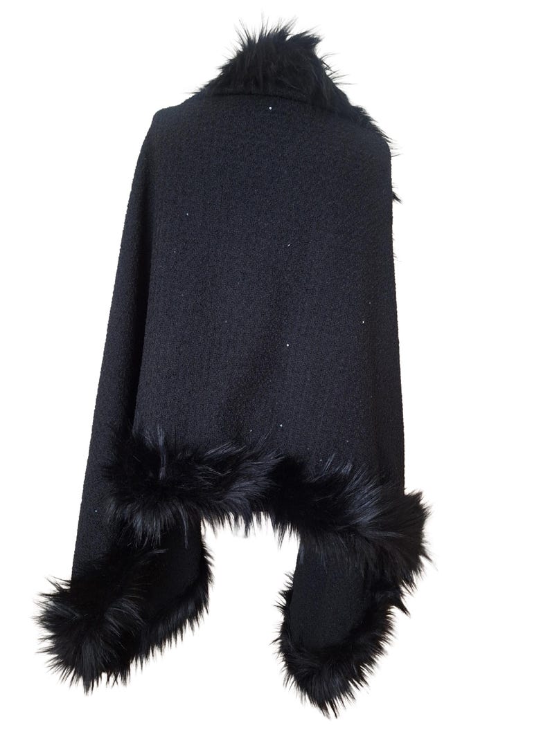 Black heavy tweed evening wrap with Racoon fur collar, styled in an asymmetrical drape for a dramatic and sophisticated winter look