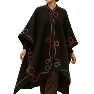 Elegant Cashmere Long Cape, Poncho by exquisite artisan cord embellishment trim, and featuring a seamless circular cut, elegant drape, and one-size oversized silhouette, Showcasing on a live model front view