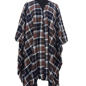 K&ouml;nnte beinhalten: Ein braunes, schwarzes und wei&szlig;es kariertes Poncho mit Fransenbesatz.