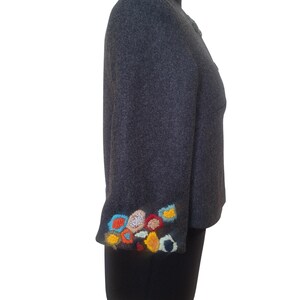 May include: A gray wool jacket with colorful embroidered flowers on the cuff.
