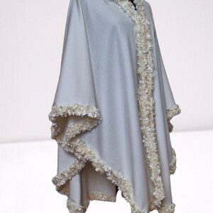 This ivory cashmere cape is a timeless luxury piece, designed as an elegant winter wrap, evening cape, or refined bridal accessory
