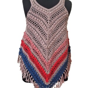 May include: A handmade crochet top in a V-neck style, featuring a mix of colors. The top has a mauve base with stripes of pink, red, and blue, and is finished with fringe along the bottom edge. The crochet work includes textured details.