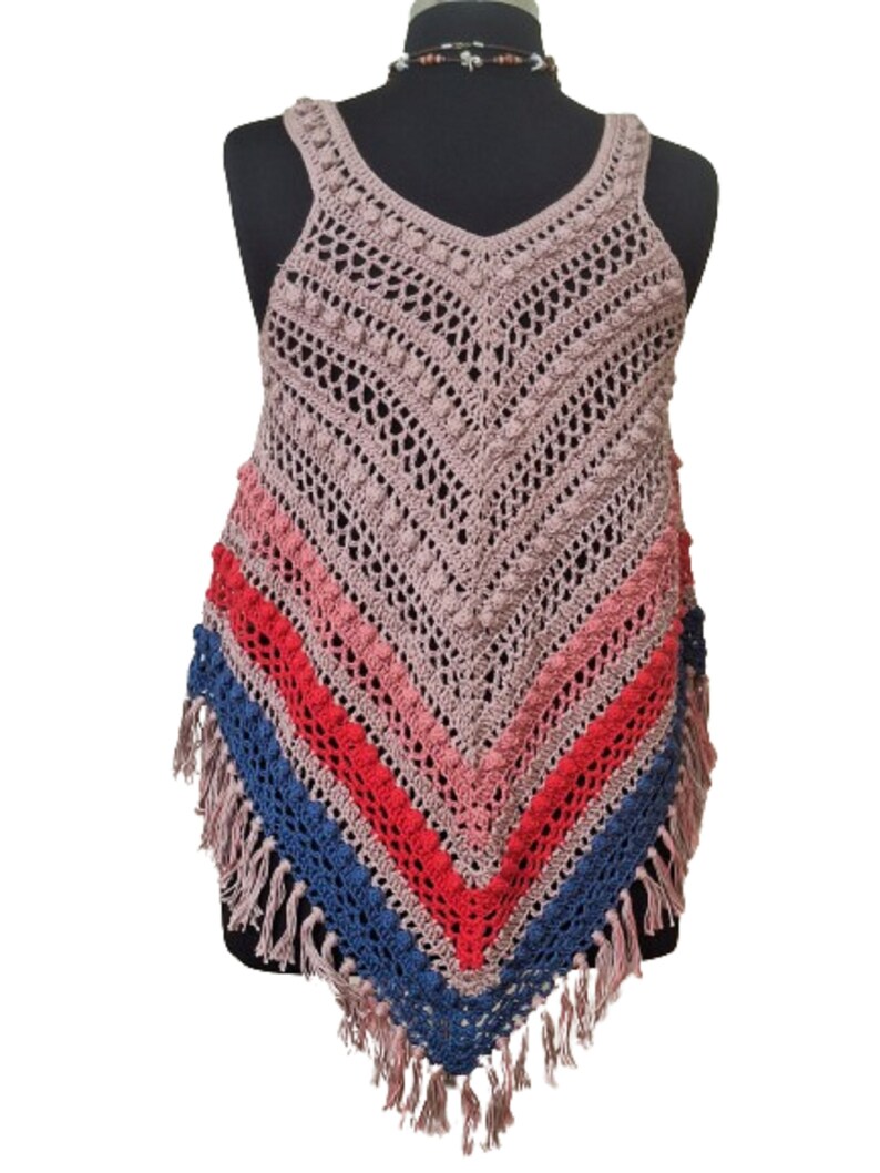 May include: A handmade crochet top in a V-neck style, featuring a mix of colors. The top has a mauve base with stripes of pink, red, and blue, and is finished with fringe along the bottom edge. The crochet work includes textured details.