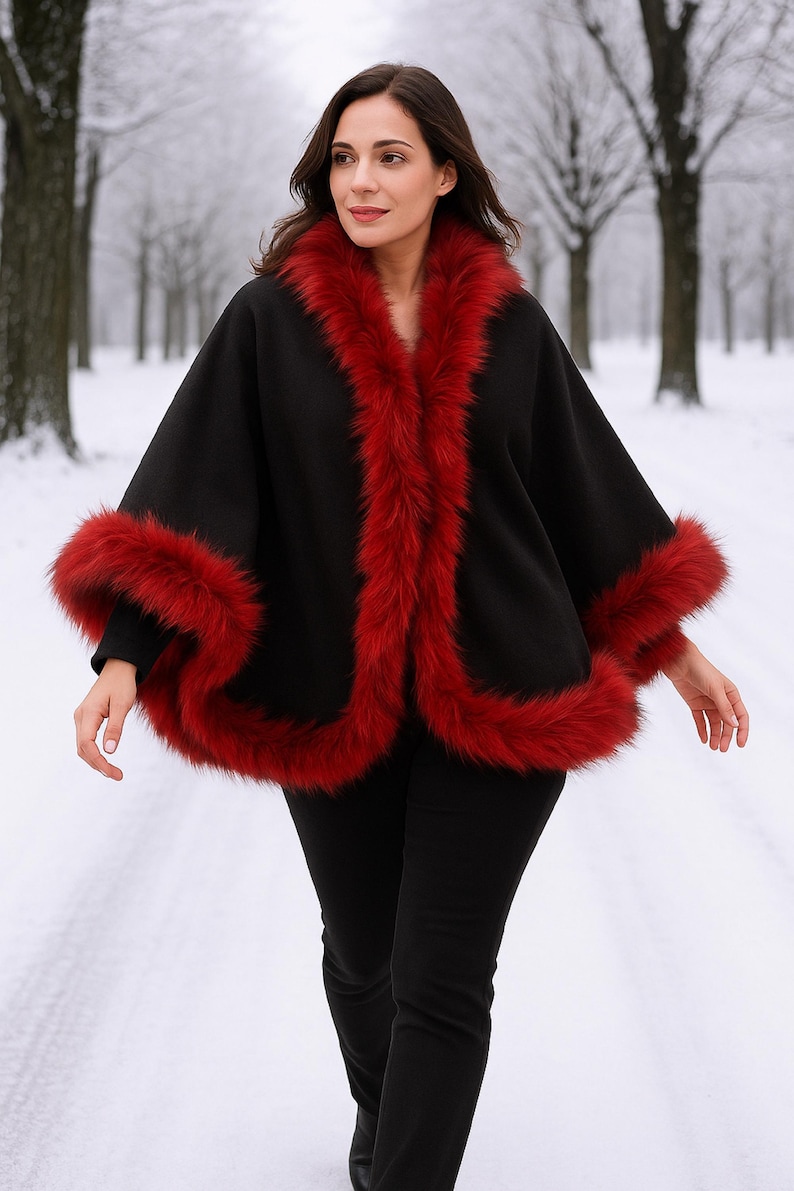 Black Alpaca Wool Cape with Red Fur Trim showcasing on a live model in a snowy forest view.