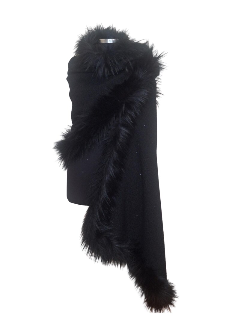 Black heavy tweed evening wrap with luxurious  fur collar, styled in an asymmetrical drape for a dramatic and sophisticated winter look