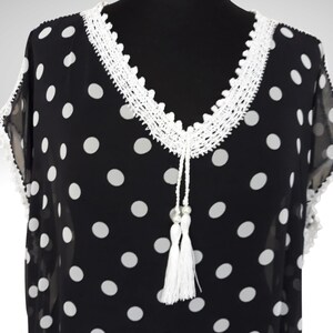 This cute boho dress has crochet embellishments on the neckline with tassels
