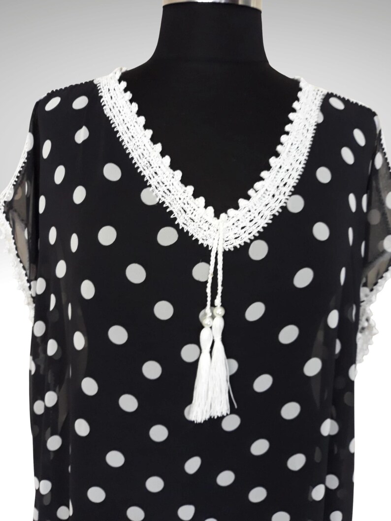 This cute boho dress has crochet embellishments on the neckline with tassels