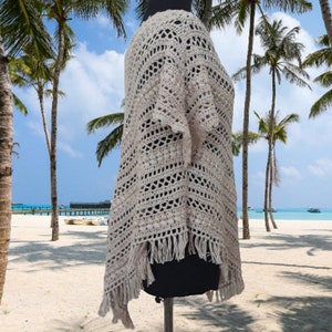 Crafted with meticulous care and attention to detail, this poncho showcases the beauty of hand knitting combined with the comfort of pure cotton.