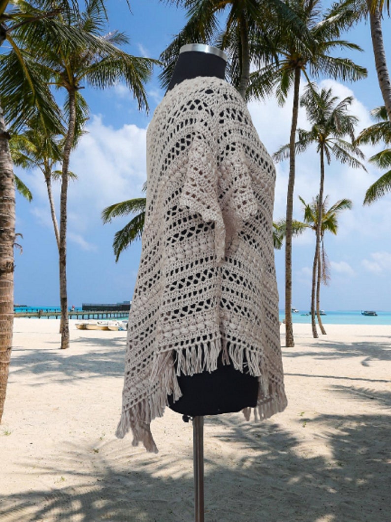 Crafted with meticulous care and attention to detail, this poncho showcases the beauty of hand knitting combined with the comfort of pure cotton.