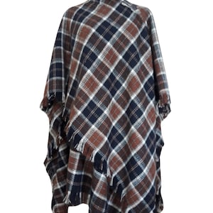 A Tan, white, and blue plaid poncho with fringe 
100% Lambswool