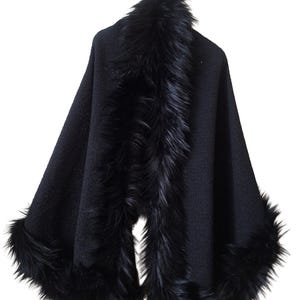 Front view of an elegant heavy black wool tweed shawl with Racoon fur trim and subtle sparkling sequins, handmade winter wrap in luxurious evening style