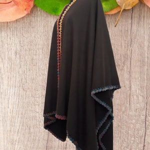 Side view of unisex baby alpaca wrap showing soft drape, lightweight warmth and artisan crochet trim.