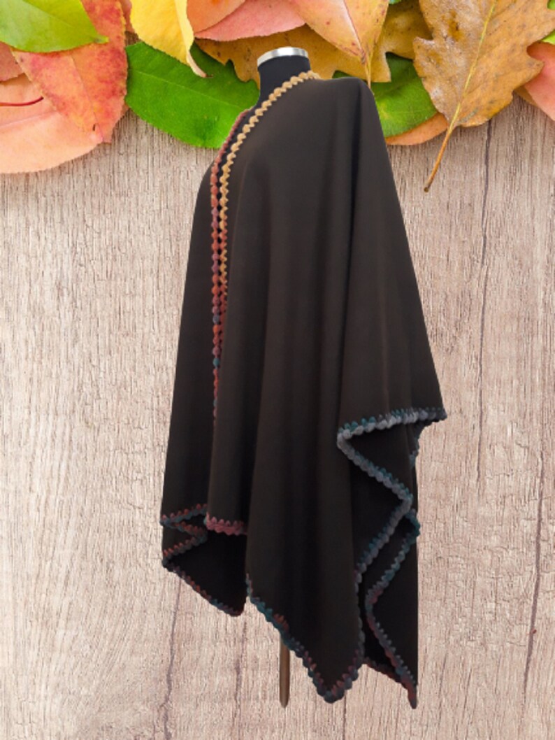 Side view of unisex baby alpaca wrap showing soft drape, lightweight warmth and artisan crochet trim.