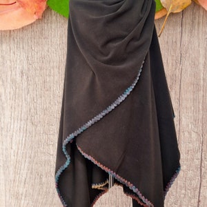 Reversible Large Cape, shawl,  poncho with a multicolored crocheted trim. The poncho is displayed on a mannequin wrap style