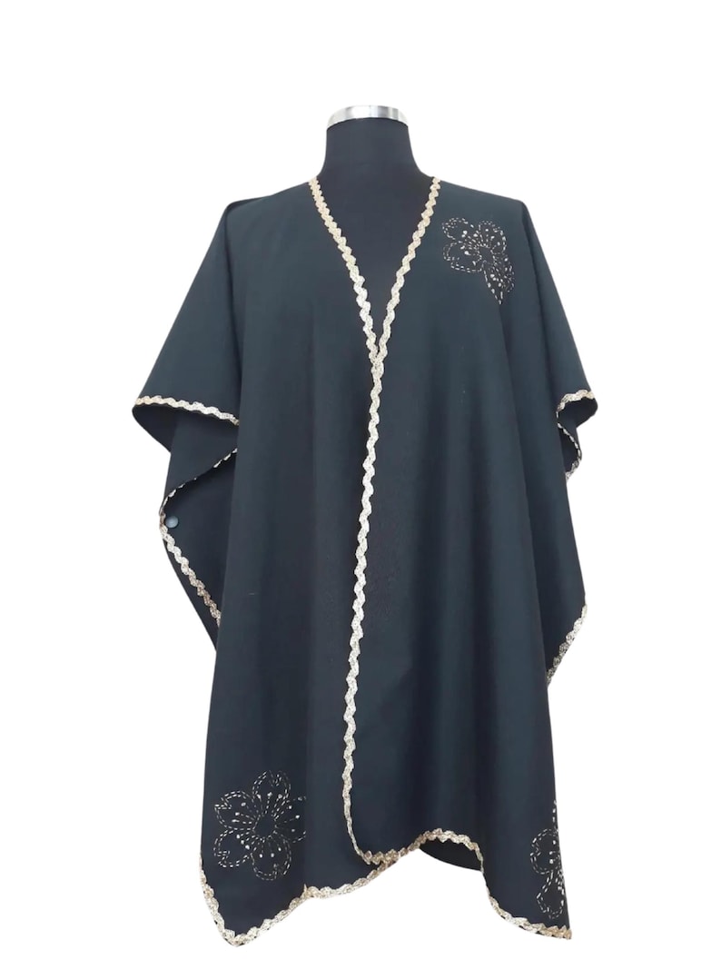 Linen  cape features hand embroidery gold trim  and flowers, with side slits which under arm snap closure  to create optional wide elbow sleeves.