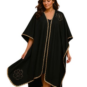 This beautiful linen cape features hand embroidery gold trim  and flowers, with side slits which under arm snap closure  to create optional wide elbow sleeves.