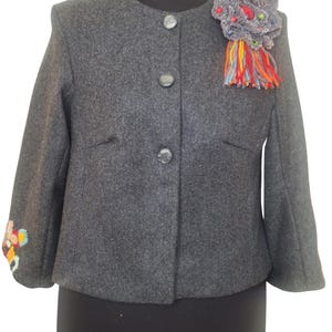 Very versatile, this jacket may wear with jeans, skirt or dress.
This beautiful jacket is reworked and redecorated with hand embroidery and different textiles.