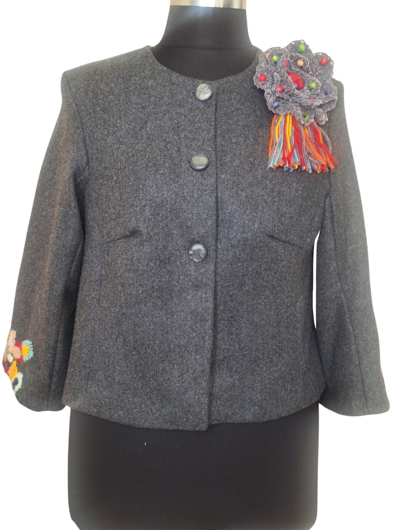 Very versatile, this jacket may wear with jeans, skirt or dress.
This beautiful jacket is reworked and redecorated with hand embroidery and different textiles.