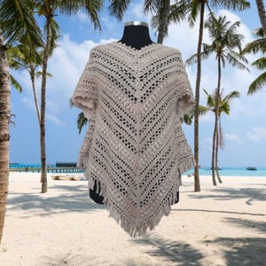 Handcrochet poncho in beautiful lace design on the front and back with fringed hem,  with sleeves making it perfect for both casual and formal occasions.
100% natural yarn.