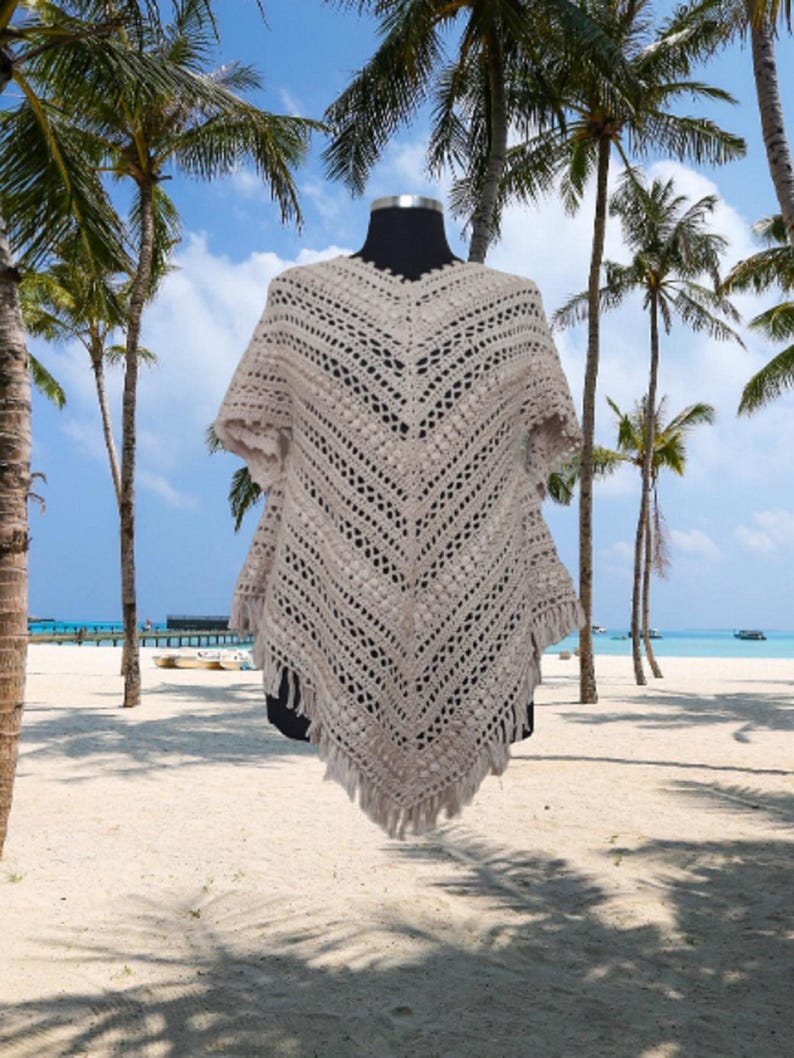 Handcrochet poncho in beautiful lace design on the front and back with fringed hem,  with sleeves making it perfect for both casual and formal occasions.
100% natural yarn.