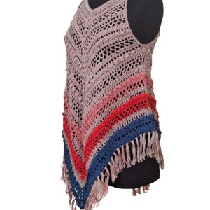 May include: A sleeveless, open-weave crochet top in a dusty rose color. The top features a V-neck and a diagonal color block design with stripes of pink, red, and blue. The bottom edge has a fringe detail.
