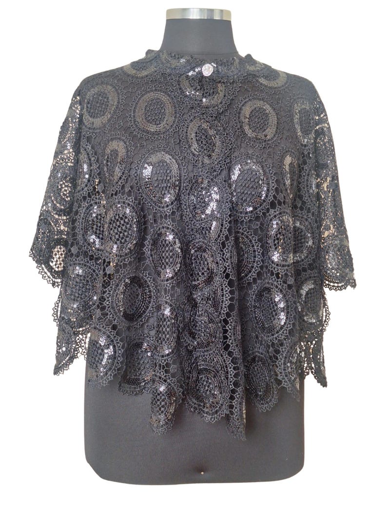 High quality sequinned heavy thick bobbin lace Cape.  Beautiful look with a prom dress. 
it's open front no arm hole, cape style.