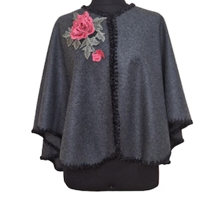 Handmade embellished with applique flower and glitery whipstich trim all around.