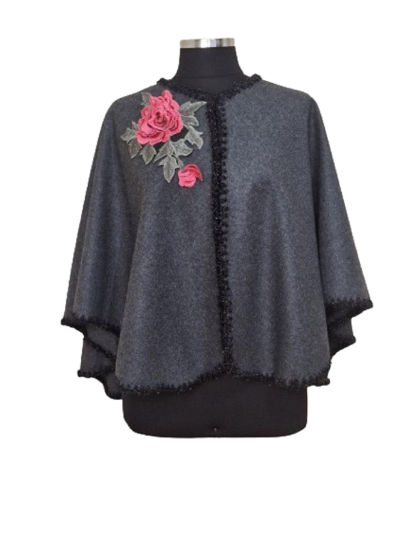 Handmade embellished with applique flower and glitery whipstich trim all around.