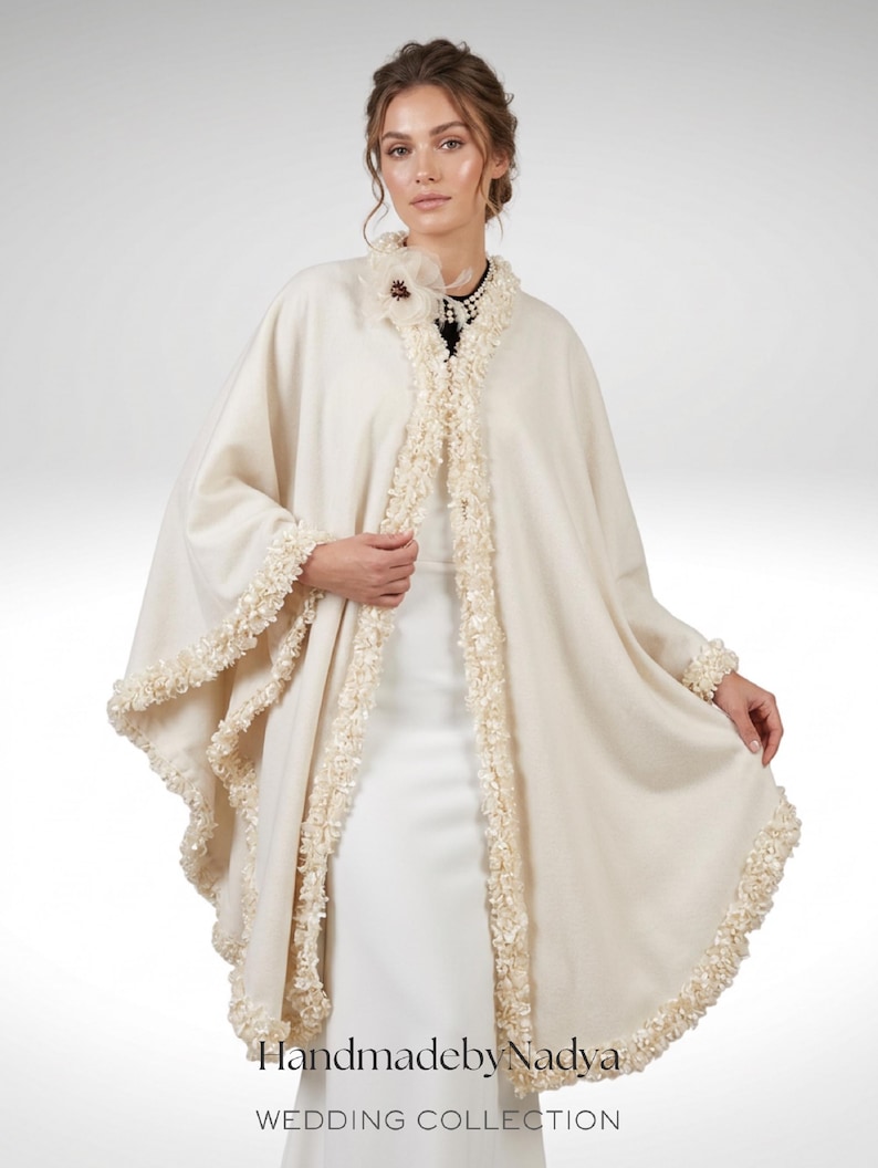 the model showcasing Front view of a luxury Ivory Bridal Cashmere Coat, Jacket with Lavish Trim, Couture Evening Cape, featuring a seamless circular cut, elegant drape, and one-size oversized silhouette.