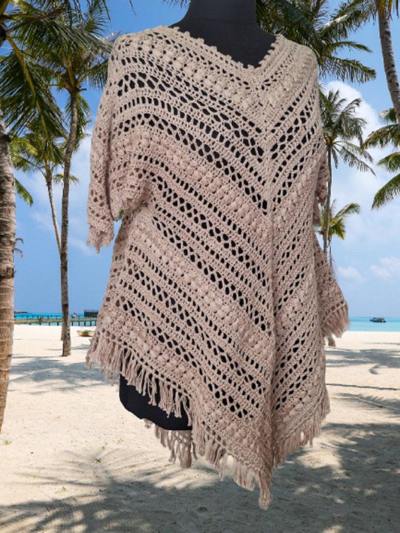 Unique handmade crochet poncho dress in breathable cotton, styled for festivals, beach days, and boho chic outfits.
