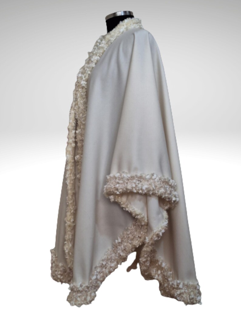 Cashmere Coat, Jacket with Lavish Trim is displayed on a mannequin against a neutral background, highlighting the texture and sparkle of the lavish trim.