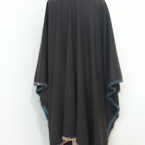Back view of reversible baby alpaca cape with colorful hand-crocheted border and flowing oversized design.