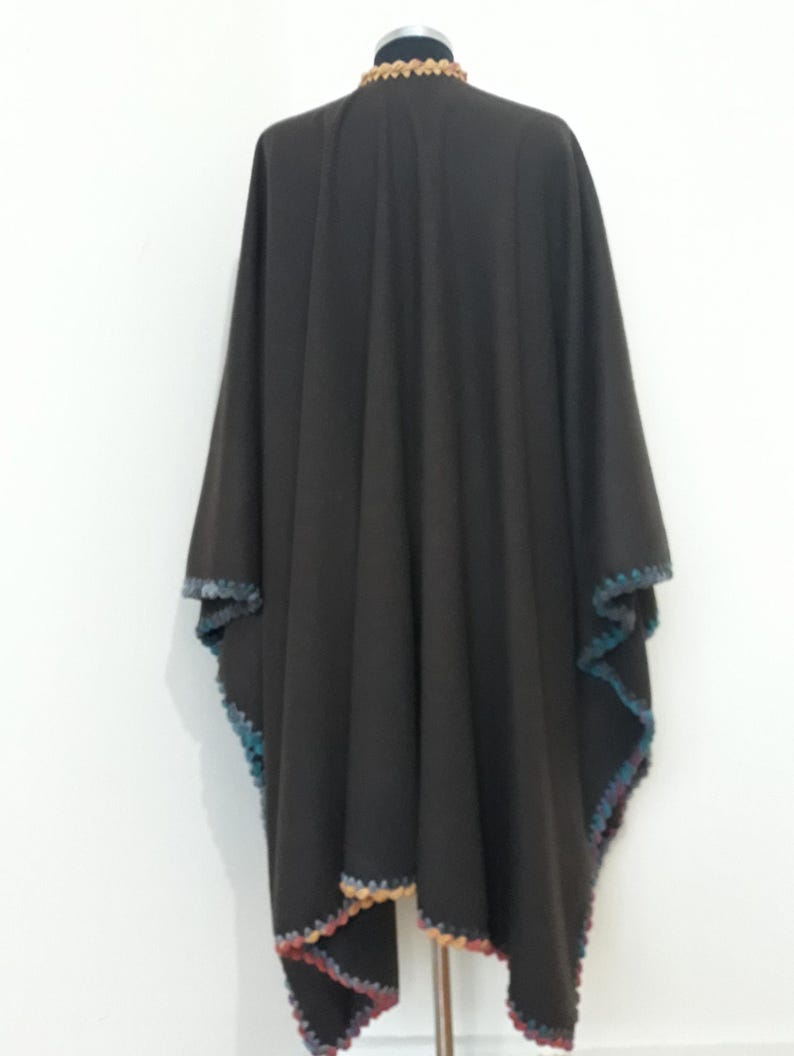Back view of reversible baby alpaca cape with colorful hand-crocheted border and flowing oversized design.