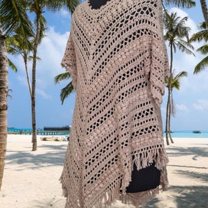 “Hand crochet cotton poncho dress in boho style with oversized fit, styled as a summer festival outfit and beach cover up.”