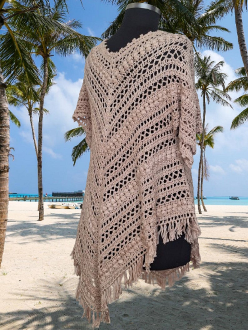 “Hand crochet cotton poncho dress in boho style with oversized fit, styled as a summer festival outfit and beach cover up.”