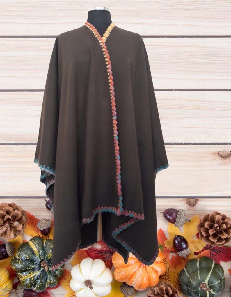 Front view of handmade baby alpaca ruana poncho featuring vibrant crochet edging and elegant draped silhouette.