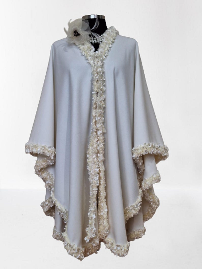 Off White Cashmere Cape, Shawl is incredibly well made and of the highest quality. A Timeless addition to your wardrobe and a definite attention getter with lavish handwork trim!