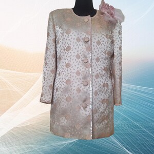 Elevate your wardrobe with this stunning vintage handsewn Silk Brocade Blazer Jacket in a soft pastel pink hue. Crafted from antique silk brocade fabric with artsy  flower brooch