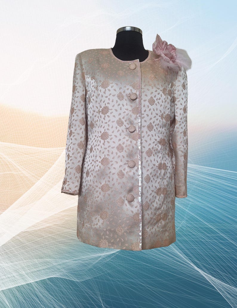 Elevate your wardrobe with this stunning vintage handsewn Silk Brocade Blazer Jacket in a soft pastel pink hue. Crafted from antique silk brocade fabric with artsy  flower brooch