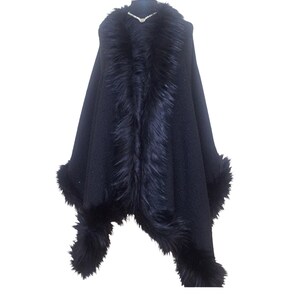 Front view of the elegant black tweed shawl with fluffy fur border, revealing the textured heavy fabric and refined winter glamour.