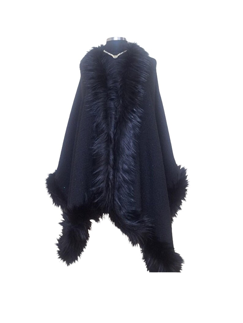 Front view of the elegant black tweed shawl with fluffy fur border, revealing the textured heavy fabric and refined winter glamour.