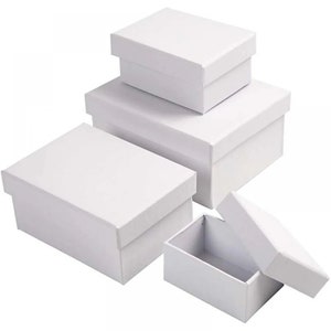 May include: Set of four white cardboard boxes of different sizes. The boxes are all rectangular and have a simple design.