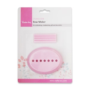 May include: Pink plastic bow maker with a rectangular mould and a round mould with six holes. The packaging has the text "CT2032-078 Crafts-Too Bow Maker For cardmaking, scrapbooking, gift and decoration www.crafts-too.com"