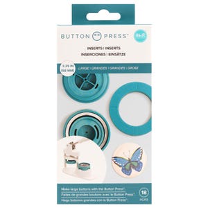 May include: A We R Memory Keepers Button Press set with two 2.25 inch (58 mm) large button inserts. The set includes a blue plastic ring insert, a blue plastic base insert, and a silver metal base insert. The package also shows a finished button with a butterfly design.