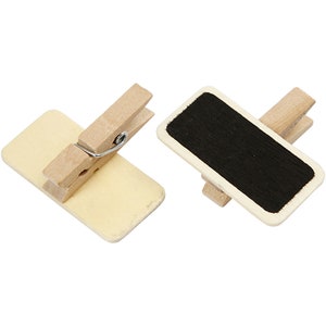 May include: Two wooden clothes pegs with a small rectangular chalkboard attached to each. The chalkboard is black and the clothes pegs are natural wood.