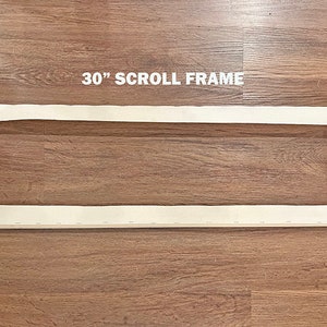 May include: A 30-inch wooden scroll frame with white canvas stretched across it. The frame is made of natural wood and has black knobs on each end.