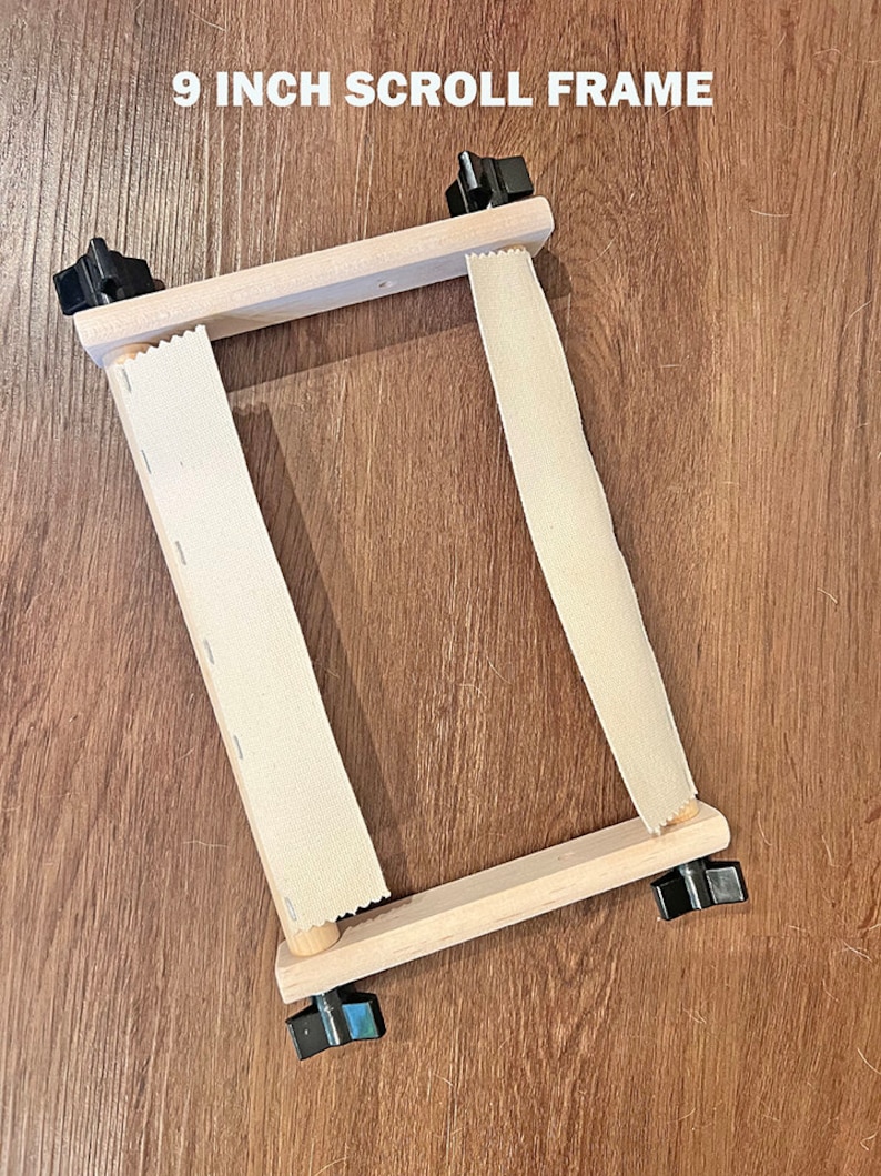 May include: A 9 inch wooden scroll frame with two white fabric strips and black knobs on each side.