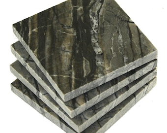 May include: Set of four square coasters made of gray and black marble with a natural veined pattern.