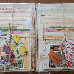 May include: Two bundles of assorted vintage paper ephemera, including maps, book pages, and tickets, wrapped in twine. Each bundle features a decorative tag, one with a lemon print and one with a floral print, plus various postage stamps.