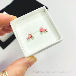 Pink skate stud earrings for roller skater lover with a pink and red design. KookyTwo